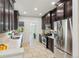 Bright kitchen with stainless appliances, dark cabinets, and stone flooring for a modern look at 2738 W 38Th Ave, Denver, CO 80211