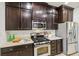 Kitchen featuring dark wood cabinets, stainless steel appliances, and ample counter space at 2738 W 38Th Ave, Denver, CO 80211