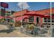 Inviting restaurant exterior with outdoor seating, red umbrellas, and hanging flower baskets at 2738 W 38Th Ave, Denver, CO 80211