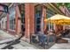 Charming restaurant exterior with large windows, brick accents, and outdoor patio seating under yellow umbrellas at 2738 W 38Th Ave, Denver, CO 80211