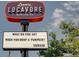 Leevers Locavore sign with a humorous message under a blue sky, highlighting the local and fresh food focus at 2738 W 38Th Ave, Denver, CO 80211