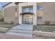 Close up shot of the entrance to the building with double doors and concrete stairs at 2460 W Caithness Pl # 104, Denver, CO 80211