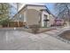 Brick building featuring parking and landscaping, showcasing the front facade at 2460 W Caithness Pl # 104, Denver, CO 80211