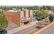 Aerial shot of the Gothic Theatre, showcasing architecture and parking, surrounded by lush trees at 3024 S Sherman St, Englewood, CO 80113
