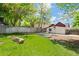 A spacious backyard with lush green grass, wooden fence, and metal planter at 3024 S Sherman St, Englewood, CO 80113