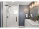 The bathroom has a glass-enclosed shower and a white vanity with a modern sink and faucet at 3024 S Sherman St, Englewood, CO 80113