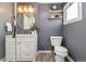 Stylish bathroom features white vanity, wood shelves, new fixtures and finishes at 3024 S Sherman St, Englewood, CO 80113