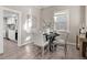 Dining area with a round table set for four, bright window and view to the kitchen at 3024 S Sherman St, Englewood, CO 80113