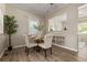 Dining area features round wooden table with seating for four and lots of natural light at 3024 S Sherman St, Englewood, CO 80113