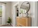 Bright entryway featuring a wooden shoe cabinet, modern mirror, and decor at 3024 S Sherman St, Englewood, CO 80113