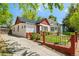 Charming home with well-maintained front yard, brick border, and a quaint metal fence at 3024 S Sherman St, Englewood, CO 80113