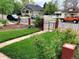 Charming home with a well-maintained lawn, wrought iron fence, and a sidewalk at 3024 S Sherman St, Englewood, CO 80113