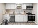 Updated kitchen with stainless steel appliances, white cabinets, and butcher block countertops at 3024 S Sherman St, Englewood, CO 80113