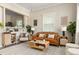 Bright living room area featuring a brown leather couch at 3024 S Sherman St, Englewood, CO 80113