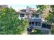 Backyard aerial view featuring a sunroom, patio, and mature trees at 4998 W 101St Ave, Westminster, CO 80031