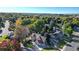 Wide aerial shot of the home with a sprawling landscape, mature trees, and a street view at 4998 W 101St Ave, Westminster, CO 80031