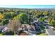 Aerial view of home, mature trees, lush landscaping, and a golf course in the background at 4998 W 101St Ave, Westminster, CO 80031