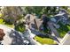 Aerial view of a well-maintained home with mature trees, a spacious yard, and a two-car garage at 4998 W 101St Ave, Westminster, CO 80031