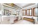 Elegant bathroom boasting a double vanity, large mirror, soaking tub, and natural light at 4998 W 101St Ave, Westminster, CO 80031