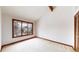 Neutral carpeted bedroom features bright windows, wood trim, and a closet at 4998 W 101St Ave, Westminster, CO 80031