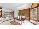 Dining space with wooden table, brick accent wall, mirrored wall and bright lighting at 4998 W 101St Ave, Westminster, CO 80031