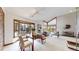 Open dining area with a wooden table, brick accent wall, and large windows at 4998 W 101St Ave, Westminster, CO 80031