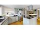 Well-lit kitchen featuring stainless steel appliances, central island with cooktop, and cabinetry at 4998 W 101St Ave, Westminster, CO 80031