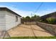 A concrete patio area with outdoor seating and a wooden fence, surrounded by a well-maintained lawn at 5369 S Sherman St, Littleton, CO 80121