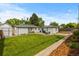 Expansive backyard features lush lawn, a patio, and detached garage, complemented by a well-maintained lawn at 5369 S Sherman St, Littleton, CO 80121