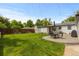 Spacious backyard featuring lush lawn, patio with umbrella table, and a well-kept white house exterior at 5369 S Sherman St, Littleton, CO 80121