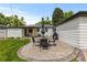 Well-maintained backyard with a patio, umbrella table, seating, a grill, lush lawn, and beautiful white home at 5369 S Sherman St, Littleton, CO 80121