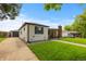 Cozy single-story home with a detached garage, long driveway, and well-kept lawn at 5369 S Sherman St, Littleton, CO 80121