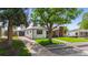 A home with a detached garage, mature trees, and a well-maintained lawn at 5369 S Sherman St, Littleton, CO 80121