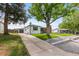 Charming single-story house with a detached garage, long driveway, and landscaped front yard at 5369 S Sherman St, Littleton, CO 80121