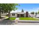 Charming single-story home featuring a brick chimney, covered porch, and a well-maintained lawn at 5369 S Sherman St, Littleton, CO 80121
