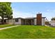 Attractive single-story home boasting a covered porch, brick chimney, and lush green lawn at 5369 S Sherman St, Littleton, CO 80121