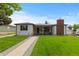 Charming single-story home with a well-manicured front yard and covered front porch with a swing at 5369 S Sherman St, Littleton, CO 80121