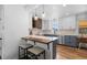 Modern kitchen featuring white cabinets, stylish pendant lights, and a cozy breakfast bar at 5369 S Sherman St, Littleton, CO 80121