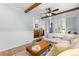 Cozy living room featuring hardwood floors, ceiling fan, and an inviting sectional couch at 5369 S Sherman St, Littleton, CO 80121