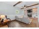 Spacious living room featuring a brick fireplace, modern lighting, and comfortable seating at 5369 S Sherman St, Littleton, CO 80121