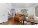 Open-concept living room with hardwood floors, stylish seating, and seamless flow to the kitchen at 5369 S Sherman St, Littleton, CO 80121