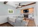 Cozy living room featuring a brick fireplace, built-in shelving, and wood beam ceilings at 5369 S Sherman St, Littleton, CO 80121