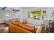 Bright living room featuring a large window with front porch view and modern furnishings at 5369 S Sherman St, Littleton, CO 80121