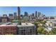 Rooftop view of the city skyline, with a mix of modern and historic buildings, and lush greenery at 837 E 17Th Ave # 2K, Denver, CO 80218