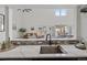 Bright kitchen view showcasing a stainless steel sink, modern countertops and cabinetry with a view into the living room at 837 E 17Th Ave # 2K, Denver, CO 80218