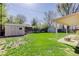 Backyard with lawn, patio, storage sheds, wood fence, and comfortable outdoor living space at 6280 Quay St, Arvada, CO 80003