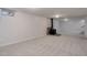 Finished basement with neutral carpet, gas burning fireplace with stone hearth, and recessed lighting at 6280 Quay St, Arvada, CO 80003