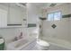 Bright bathroom with updated fixtures, bathtub, and green tile accents at 6280 Quay St, Arvada, CO 80003