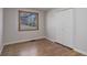 Bedroom with hardwood floors, a window providing natural light, and a closet with folding doors at 6280 Quay St, Arvada, CO 80003