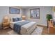 Bright bedroom with stylish furniture, rug, and natural light from two windows at 6280 Quay St, Arvada, CO 80003